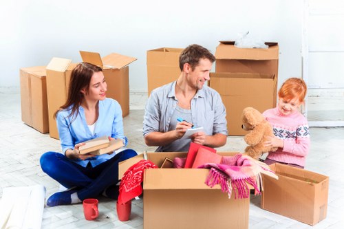 Professional movers handling office furniture near a South London business premises