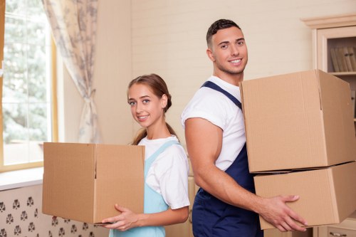 Professional mover carrying household items during a West Norwood relocation