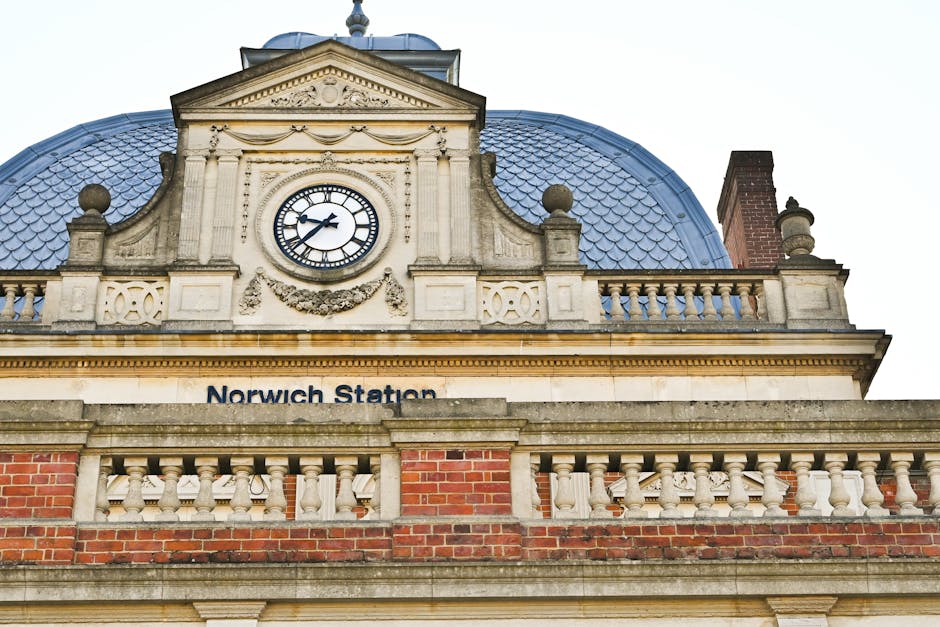 Interior view of West Norwood railway station platform at night, showing multiple railway tracks running parallel, with a yellow safety line along the edge of the platform. The platform surface is pav